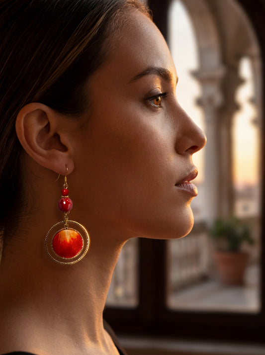 Side profile of a model wearing HECROWN red silk and ceramic statement earrings. Highlighting the bold, vibrant aesthetic of artisan handcrafted jewelry.