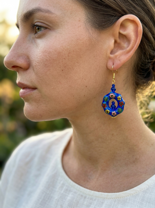 Side profile of a model wearing HECROWN 022 series hand-painted blue ceramic earrings. Elegant and vibrant artisan handcrafted jewelry for her.