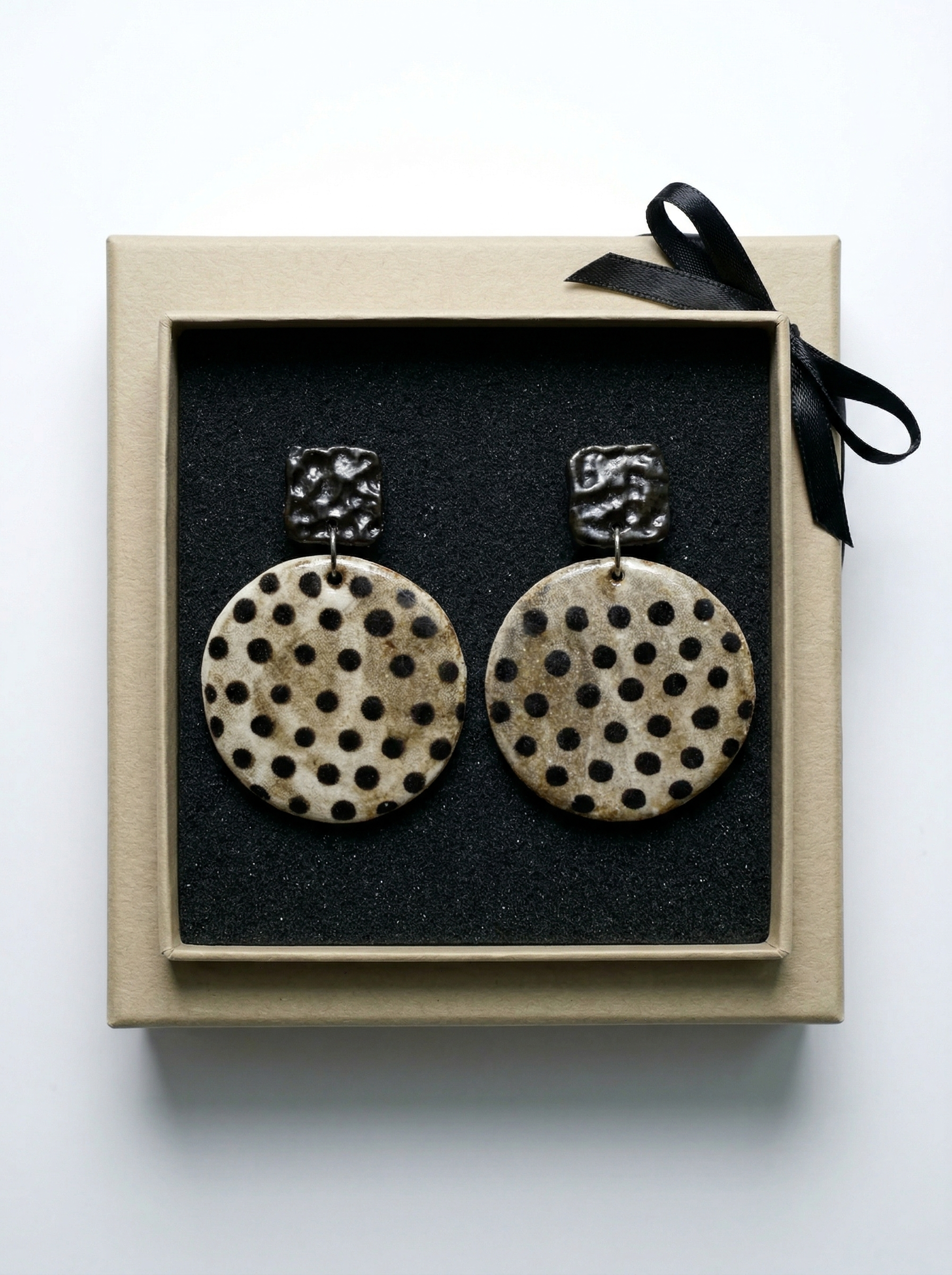 HECROWN polka dot ceramic earrings beautifully packaged in a kraft gift box with a black ribbon. A perfect anniversary or Valentine's Day gift featuring sincere artisan craftsmanship.