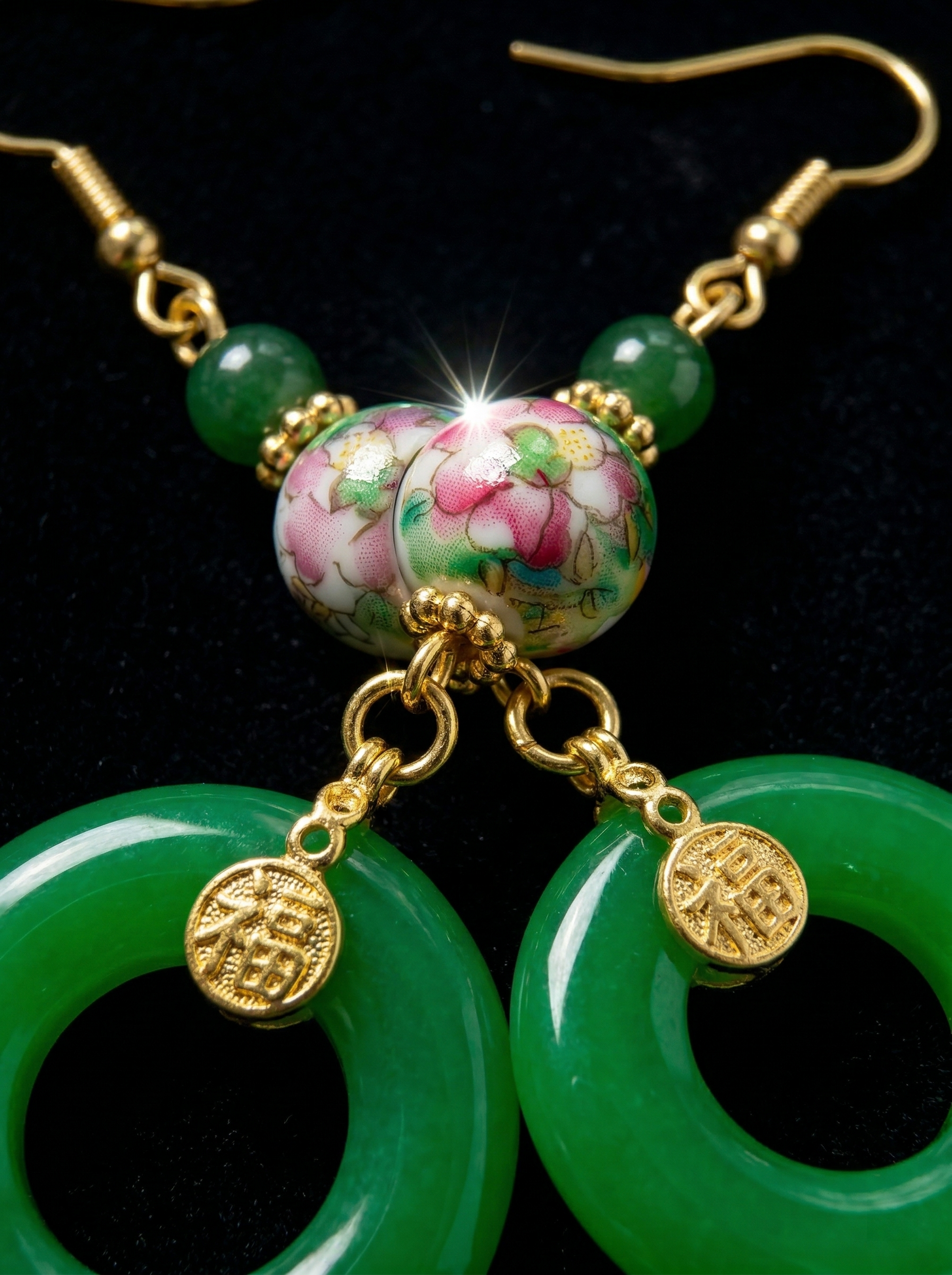 Extreme macro shot of HECROWN ceramic earrings, focusing on the hand-painted floral bead and the gold 'Fu' blessing charm. Sincere Jingdezhen craftsmanship.