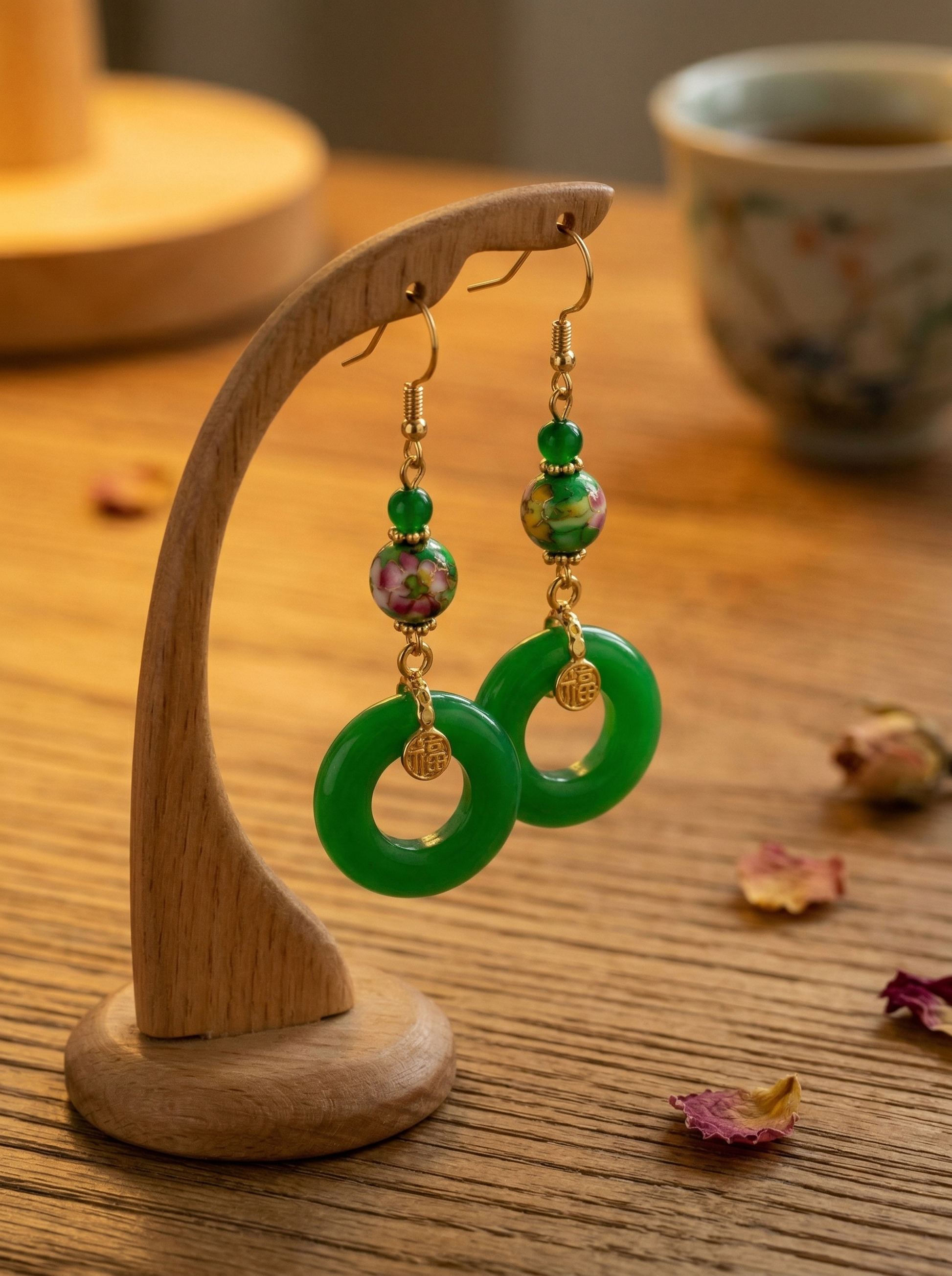 HECROWN green ceramic earrings hanging on a wooden display stand. Highlighting the tranquil and sincere wabi-sabi handmade jewelry from Jingdezhen.
