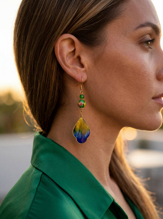 Side profile of a model wearing the HECROWN 019 silk and ceramic wing earrings. A bold, lightweight statement jewelry piece for special occasions.