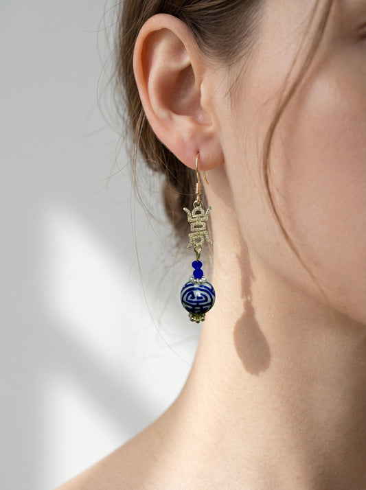 Side profile of a model wearing HECROWN 3D cobalt blue ceramic bloom bud earrings. An elegant, lightweight statement jewelry piece for weddings or gifts.