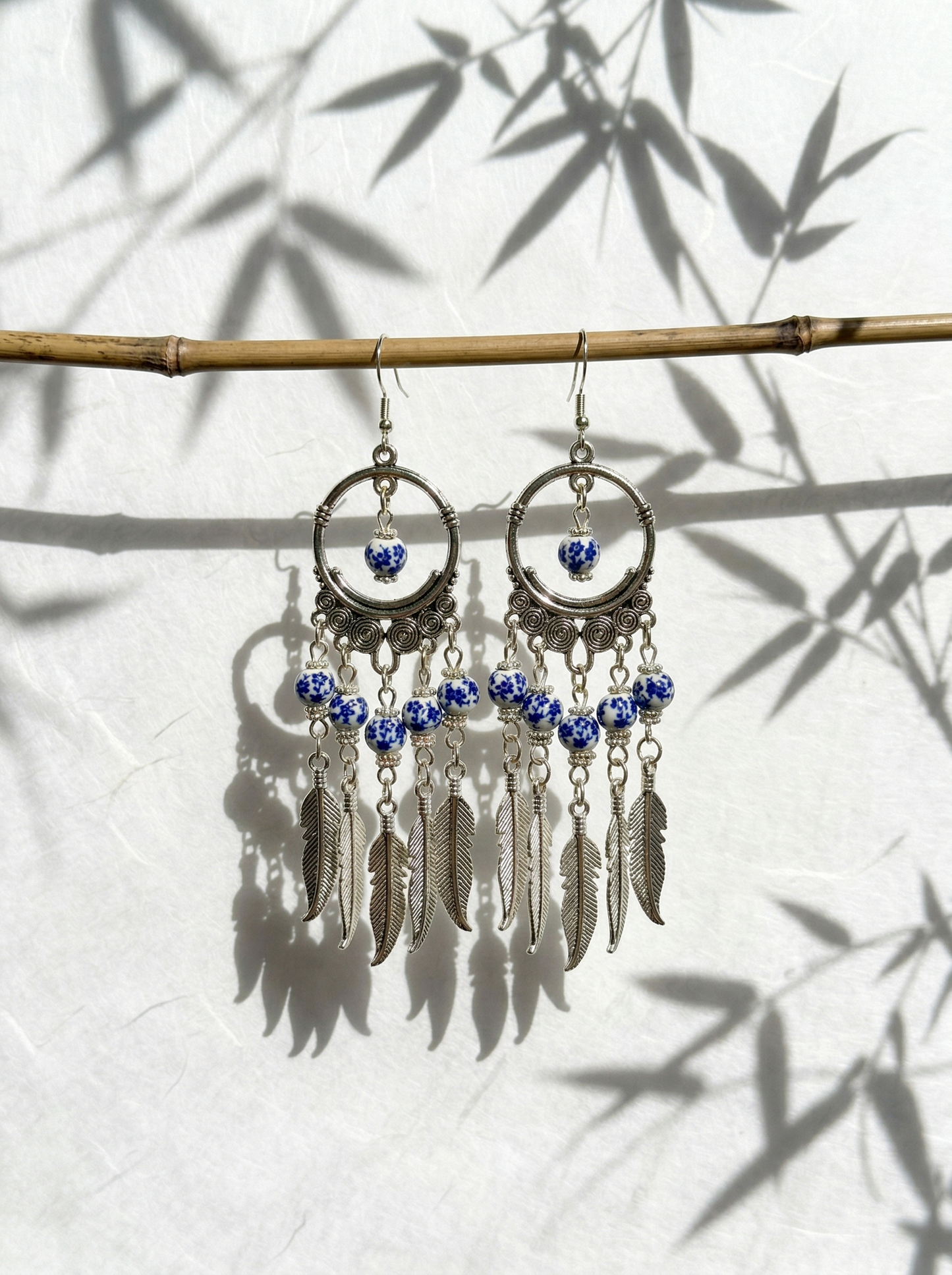A pair of HECROWN 028 cobalt blue phantom ceramic earrings with double-drop design and hand-painted patterns. Sincere Jingdezhen handmade jewelry.