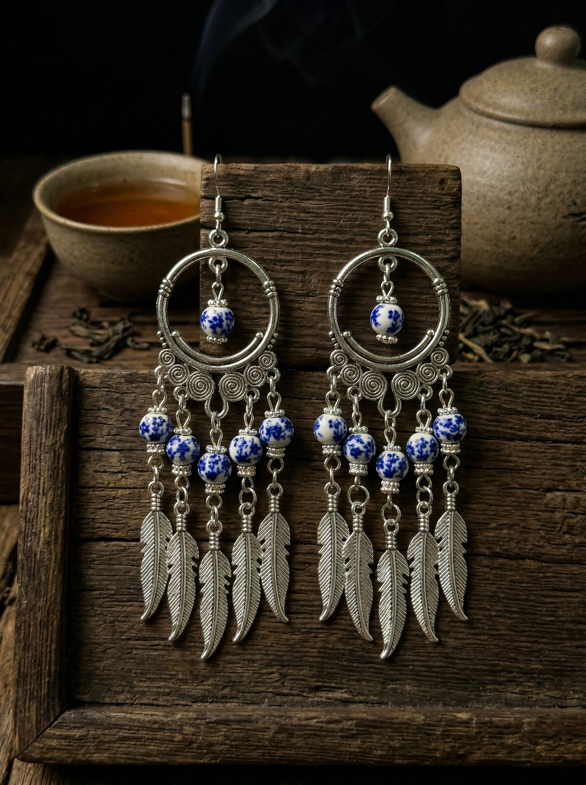 Extreme macro close-up of HECROWN blue phantom ceramic earring, focusing on the fine hand-painted cobalt blue brushstrokes. Sincere artisan craftsmanship.