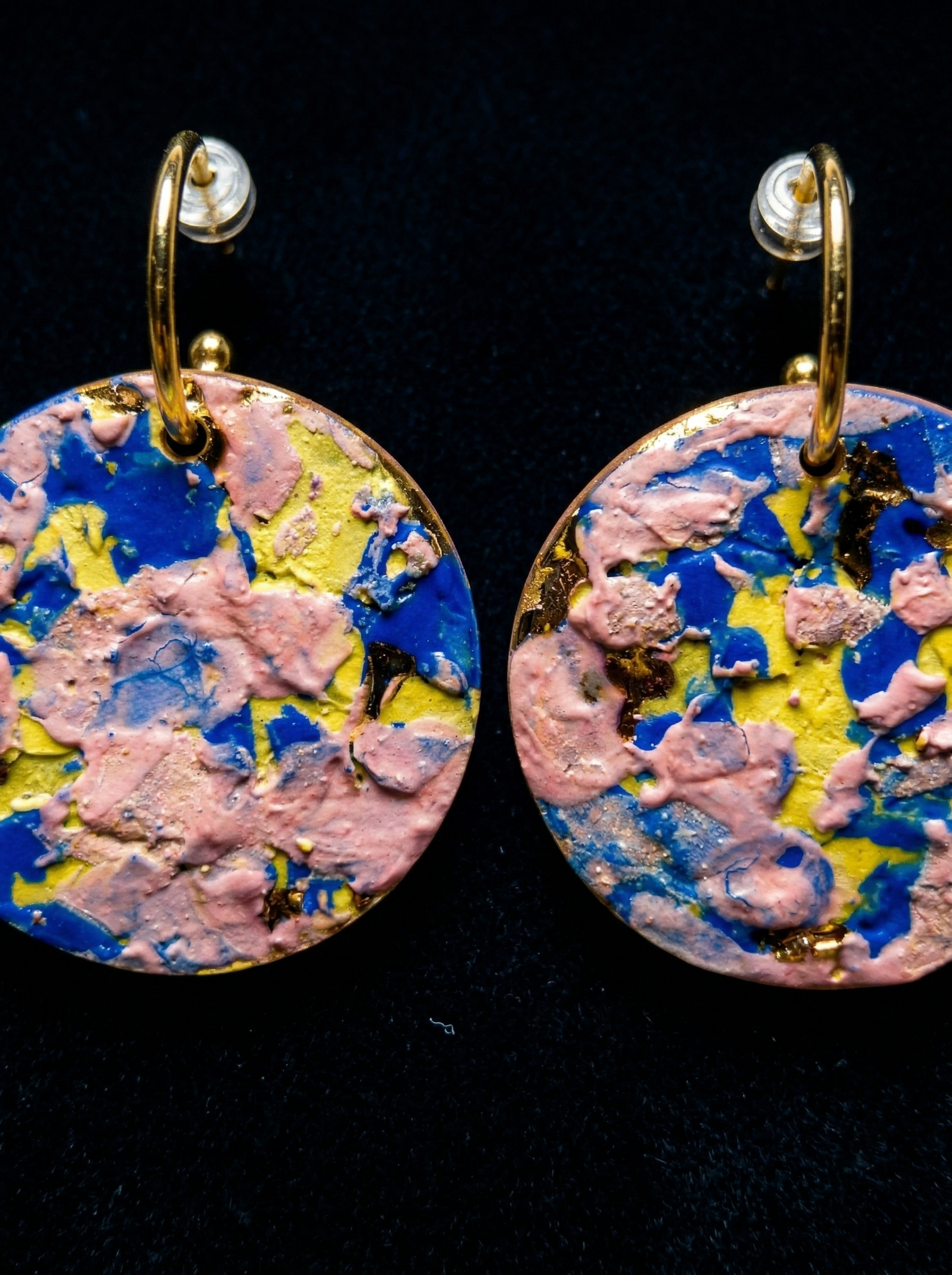 Extreme macro shot of a pair of handmade HECROWN ceramic earrings, revealing thick, painterly impasto glaze textures and subtle gold leaf accents. Every detail showcases the raw, physical concentration and sincere craftsmanship involved in Jingdezhen artisan jewelry.