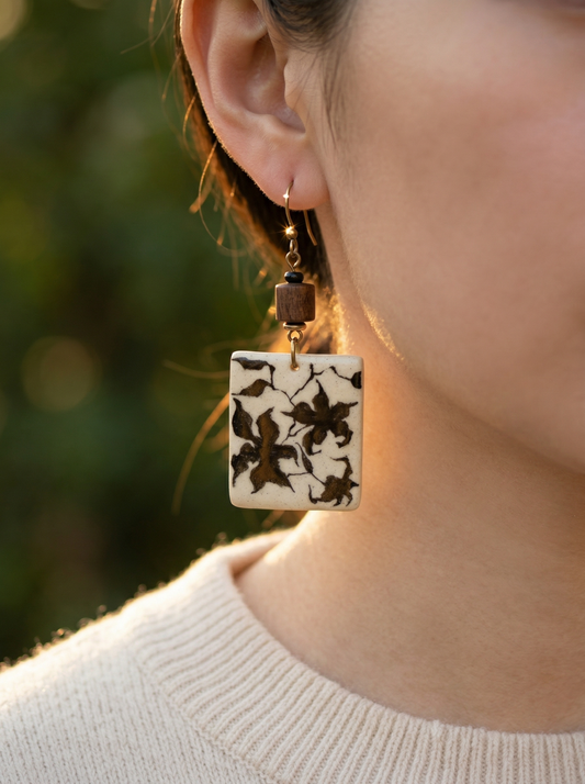 Side profile of a model wearing HECROWN vintage ceramic drop earrings in warm sunlight. The sincere hand-painted design makes it a unique anniversary gift and a warm statement of artisan jewelry.